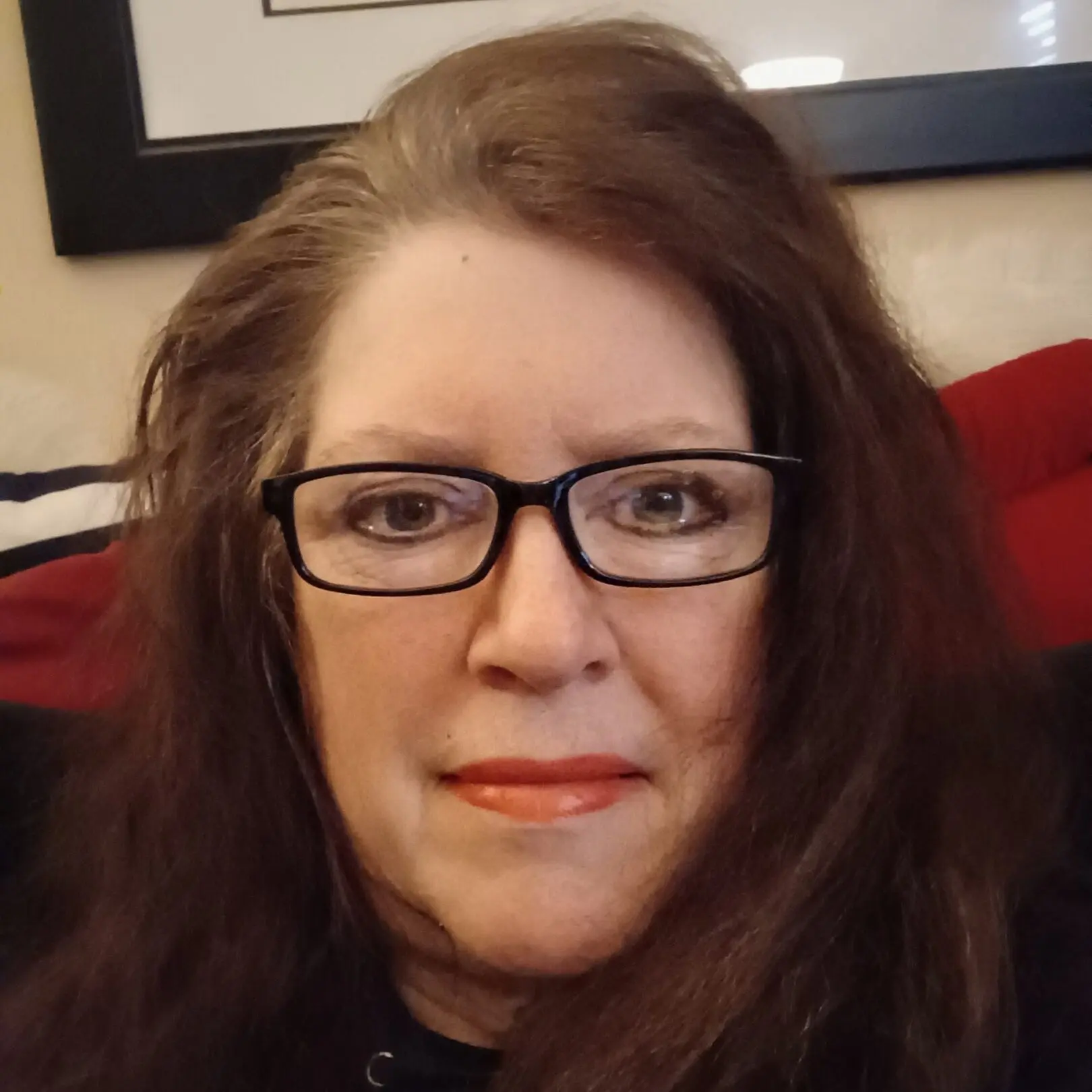 Smiling woman with glasses and long hair