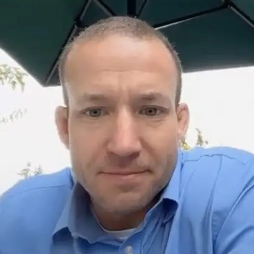 Close-up of man in blue shirt outdoors