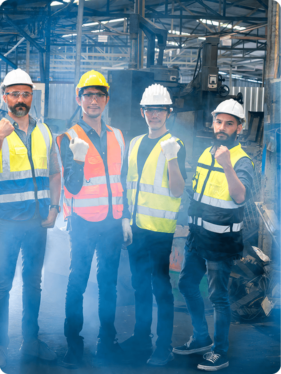 Construction workers in safety gear discussing at a site.